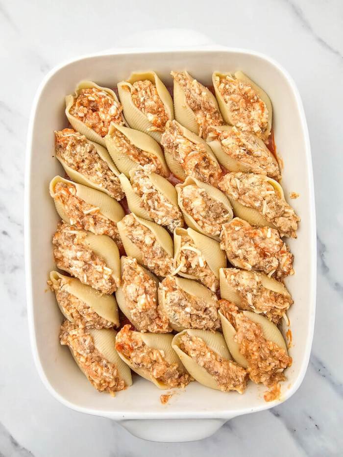 italian stuffed shells in white casserole dish