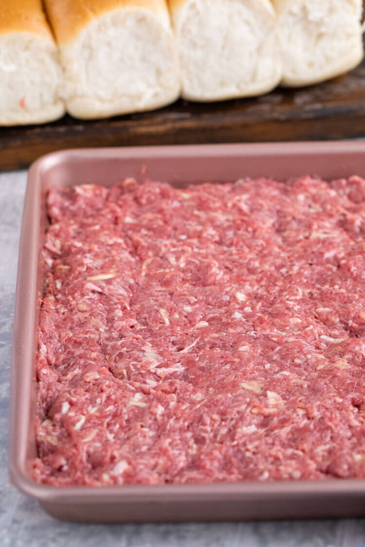 Meat on a pressed on a baking pan for White Castle Burger Copycat Recipe.