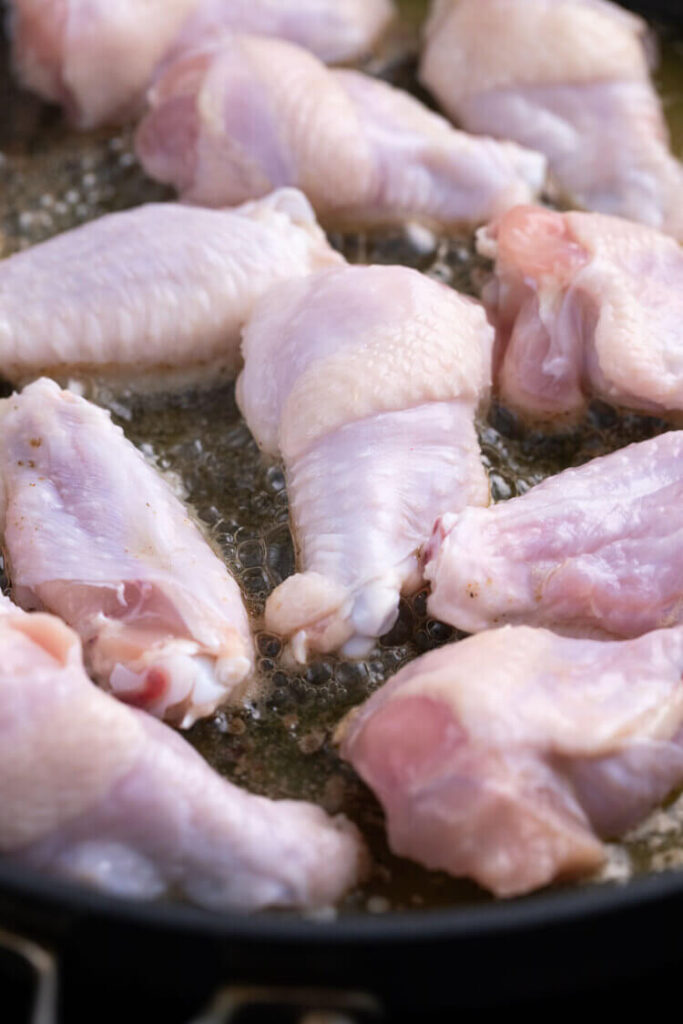 Chicken wings on a pan for Salt and Vinegar Chicken Wings recipe.