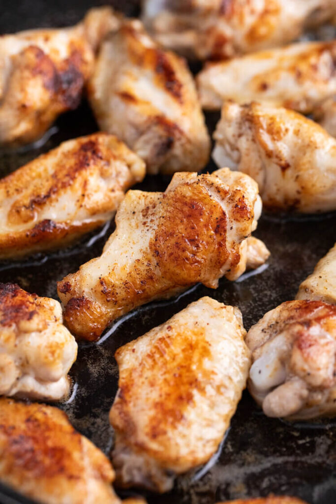 Cooked chicken wings on a pan for Salt and Vinegar Chicken Wings.