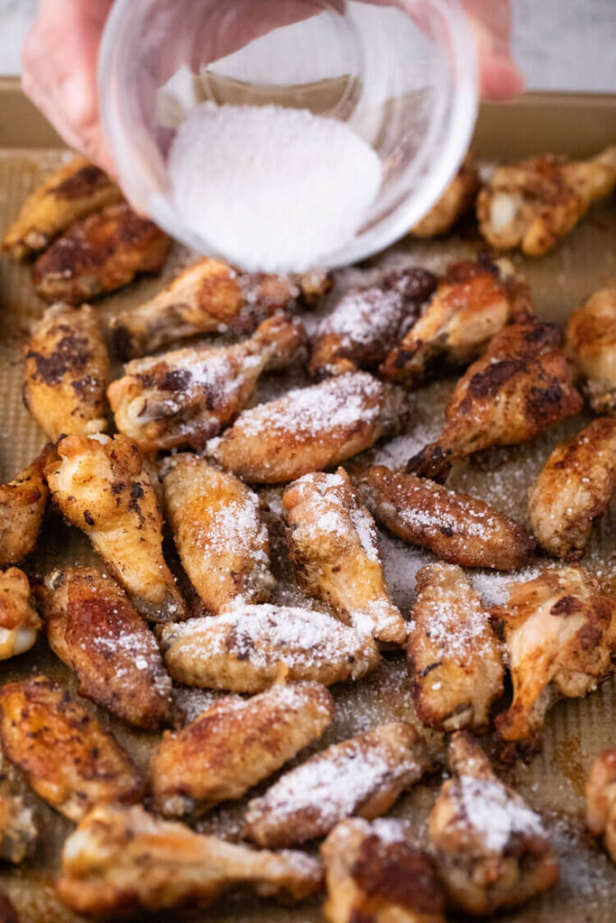 Salt and Vinegar Chicken Wings coated with vinegar salt on a pan.