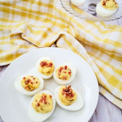 This is simply the best deviled eggs with bacon recipe you will ever try! It is a family favorite, and one of the most requested party side dishes anytime I host or attend.