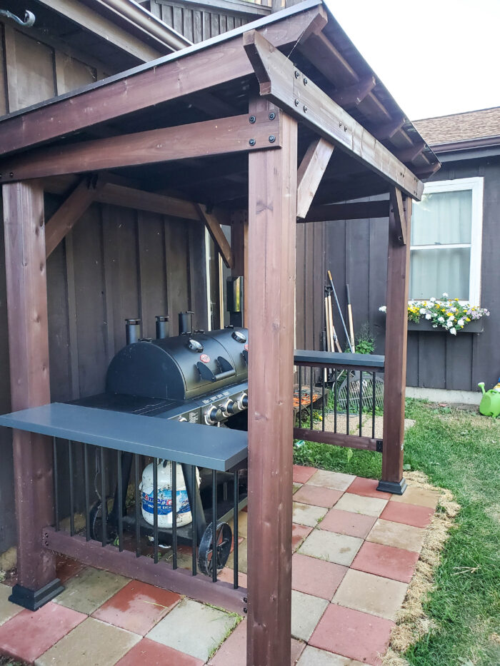 grill gazebo with grill and cement pavers