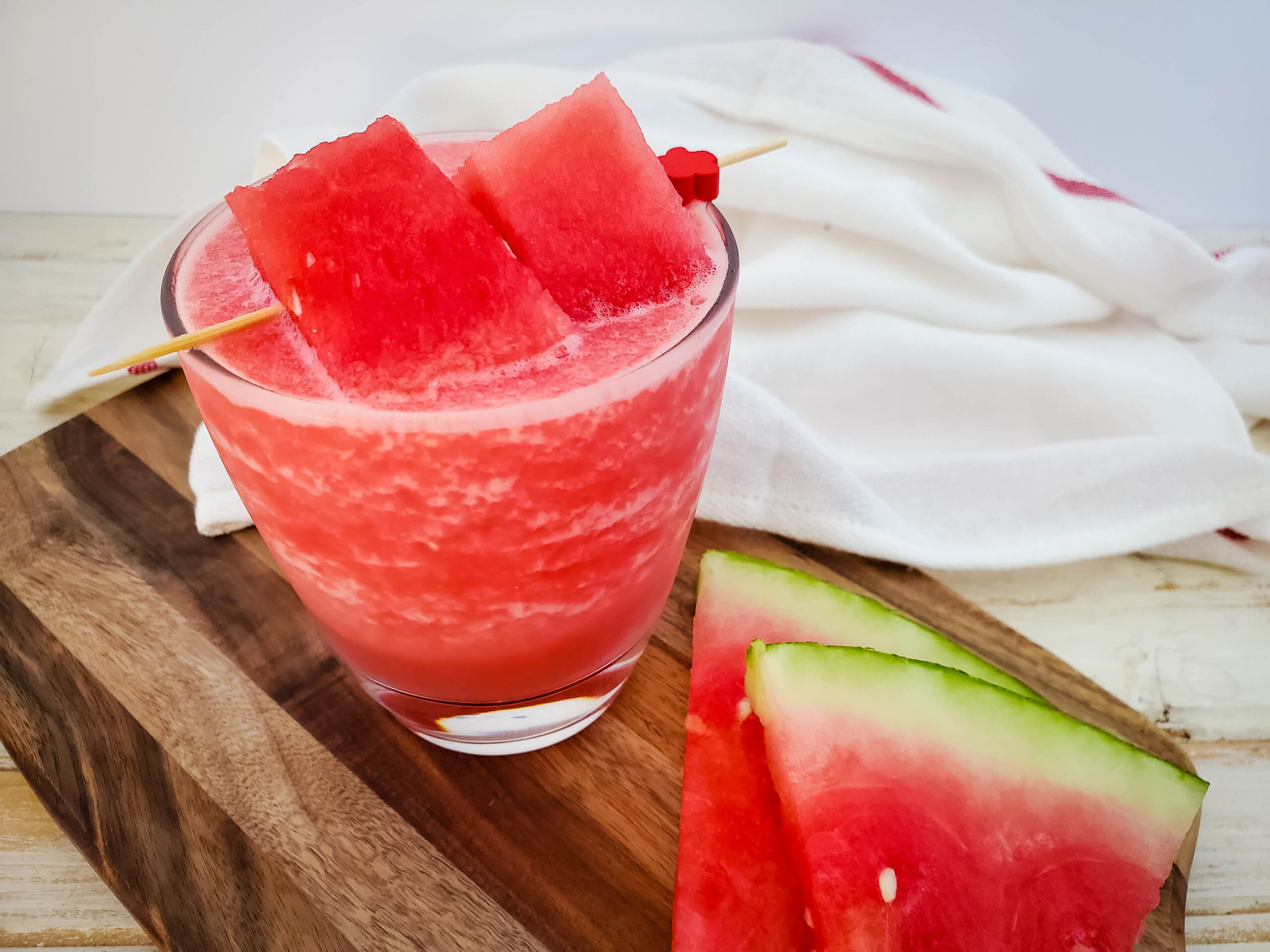 watermelon cocktail in glass with watermelon garnish