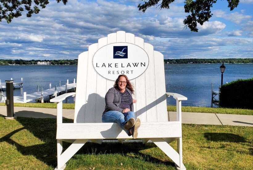 influencer Melissa Hagan sitting alomg the lakeshore of Lake Lawn Resort