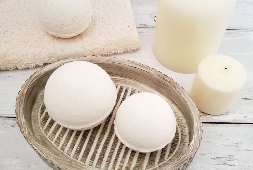 Milk Bath Bombs on a dish, a drying towel with candles