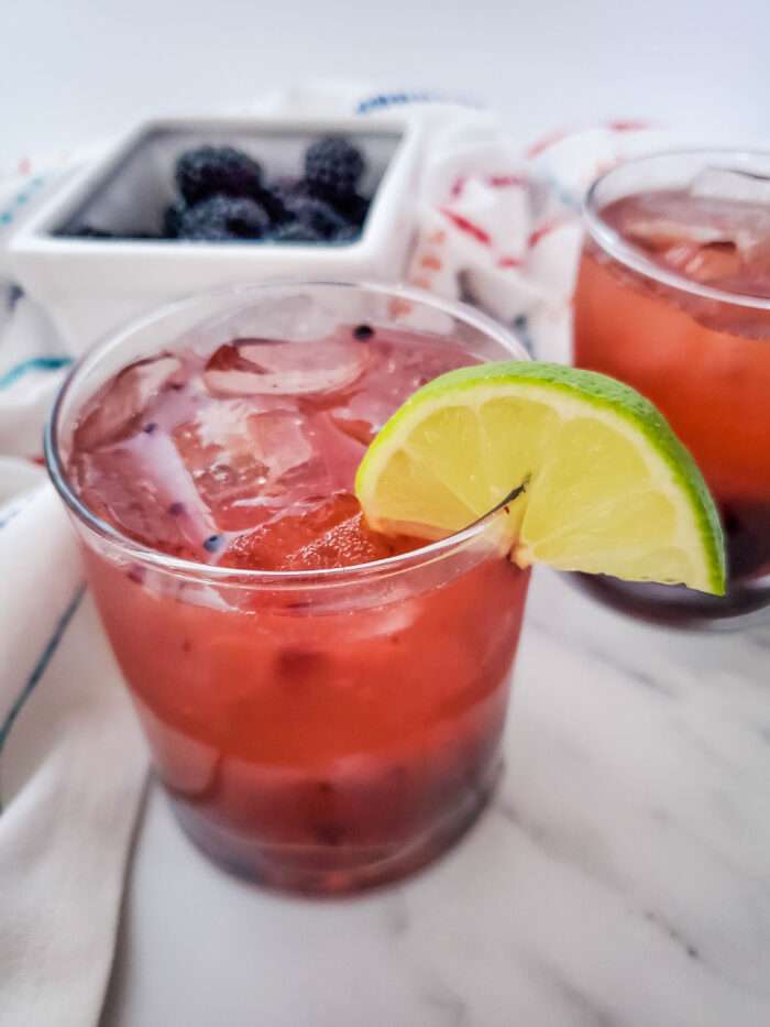 Blackberry Whiskey Lemonade with fresh blackberries in basket