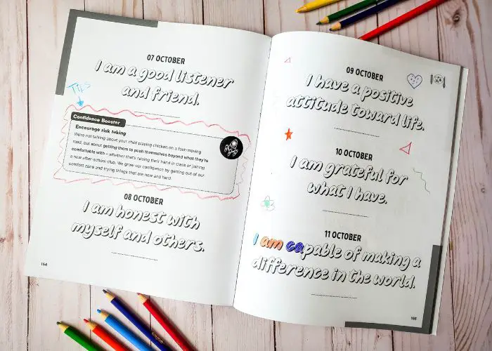 A Daily Dose of Confidence For Kids - A Confidence Boosting Book open with colored words and colored pencils