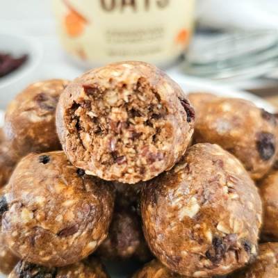 cinnamon roll protein balls - close up on bites with container in the background