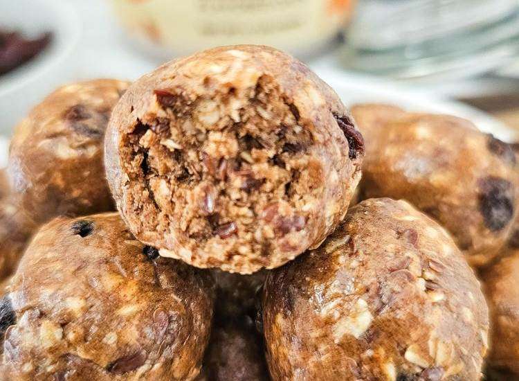 cinnamon roll protein balls - close up on bites with container in the background