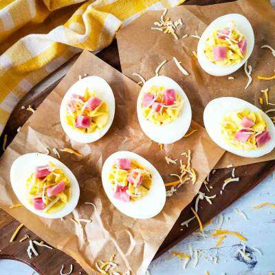 Ham and Cheese Deviled Eggs on brown parchment paper