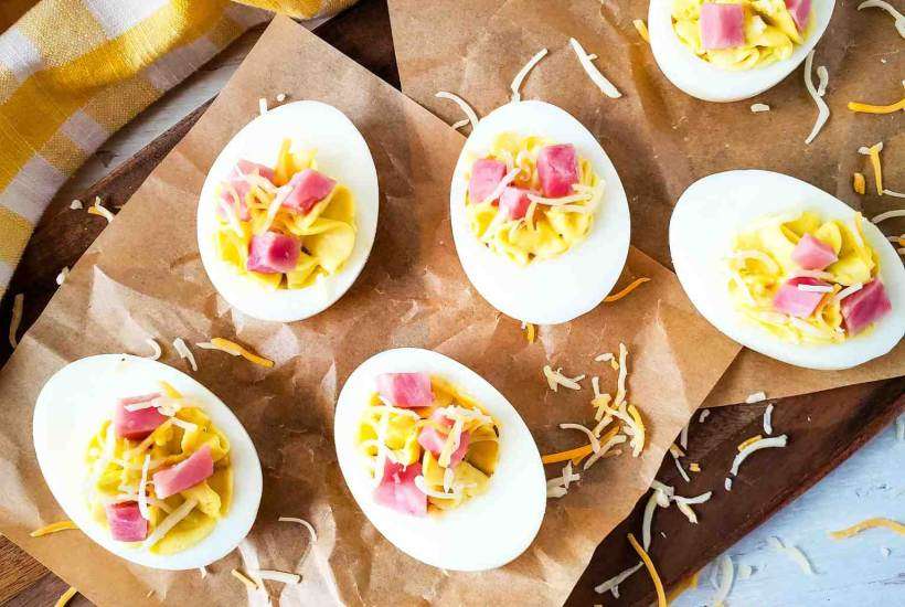 Ham and Cheese Deviled Eggs on brown parchment paper