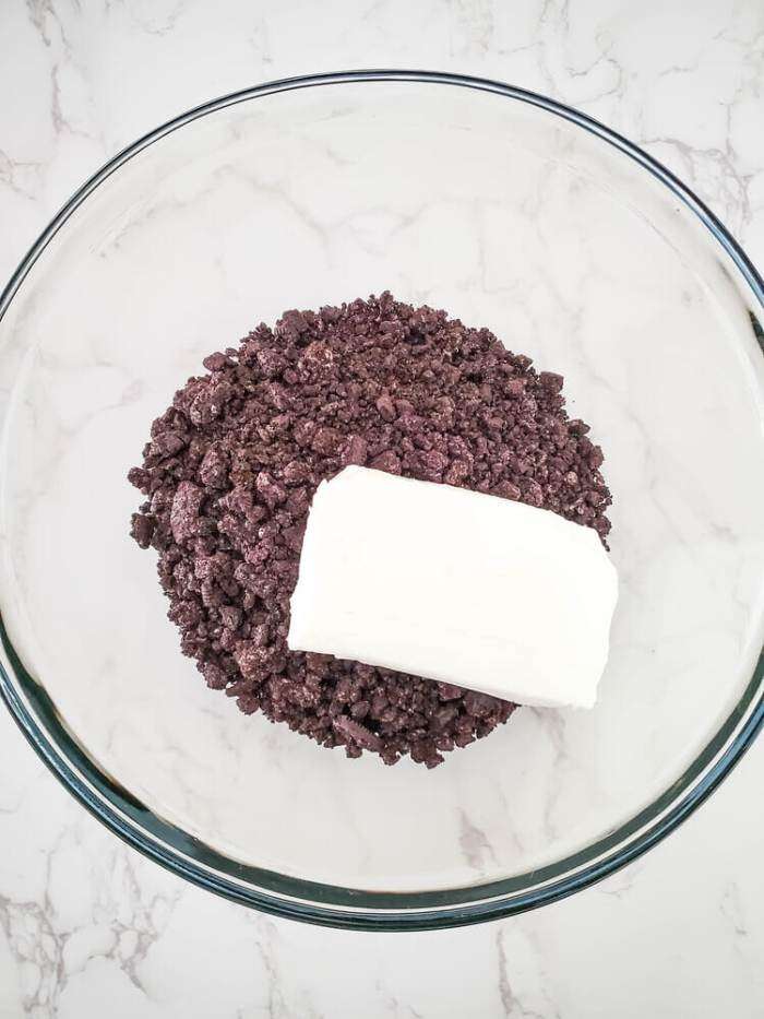 crushed cookies and cream cheese in a bowl