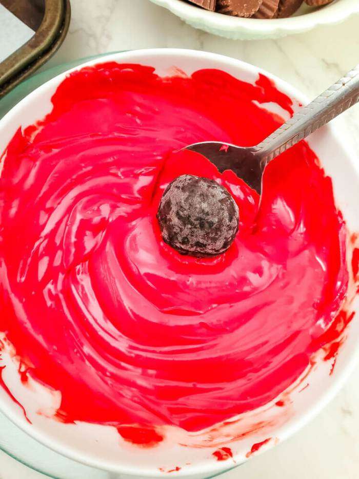 dipping the truffle ball in red chocolate