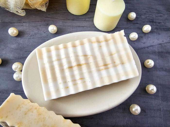 honey swirl soap bar cut into pieces on a white plate