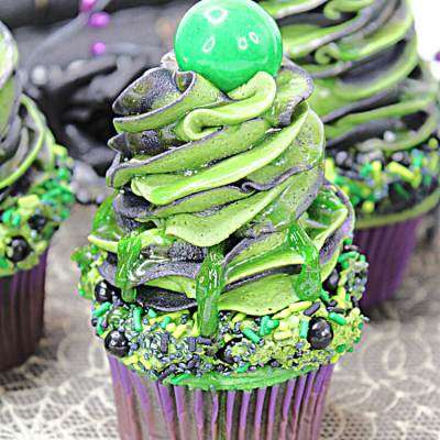 slime cupcake with high icing and a ball on top