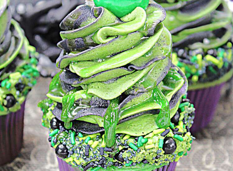 slime cupcake with high icing and a ball on top