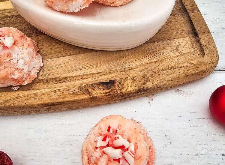 Candy Cane Shower Bombs in a white bowl on a wooden platter