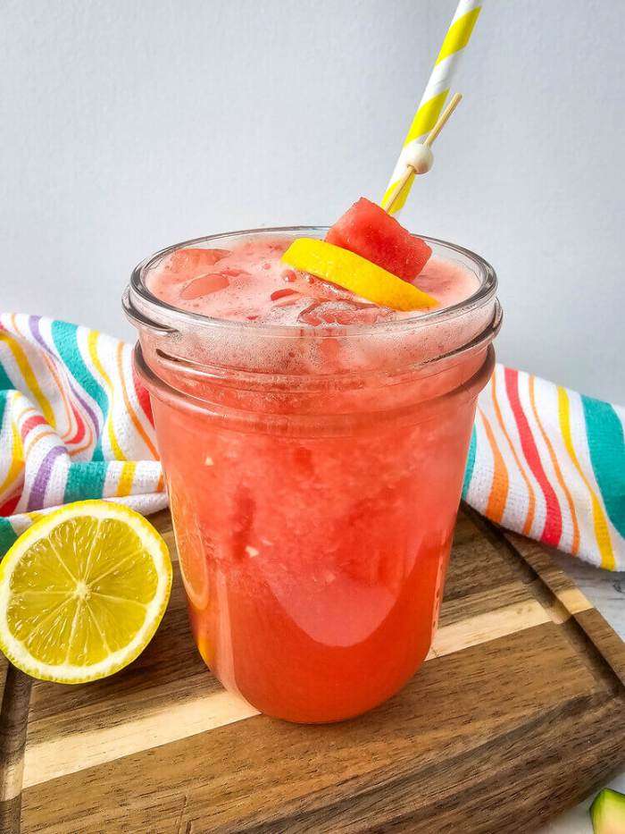 absolute watermelon and lemonade recipe on wood board with lemons and colorful towel