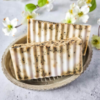 Chai Latte Swirl Soap in a pretty dish with white flowers in the background
