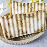 Chai Latte Swirl Soap in a pretty dish with white flowers in the background