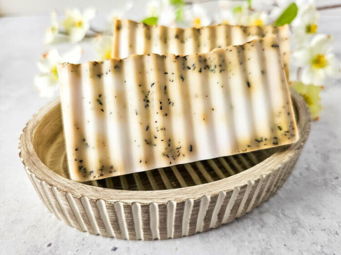 Chai Latte Swirl Soap in a pretty dish with white flowers in the background