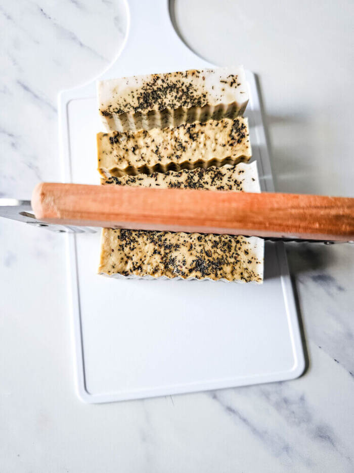 cutting the Chai Latte Swirl Soap using a special cutter