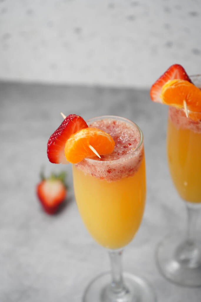 Strawberry Mimosa Recipe in glasses with orange slices and strawberry slices