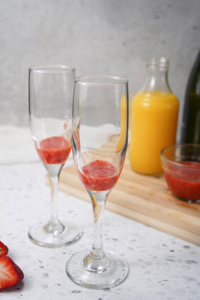 strawberry puree in the bottom of glasses