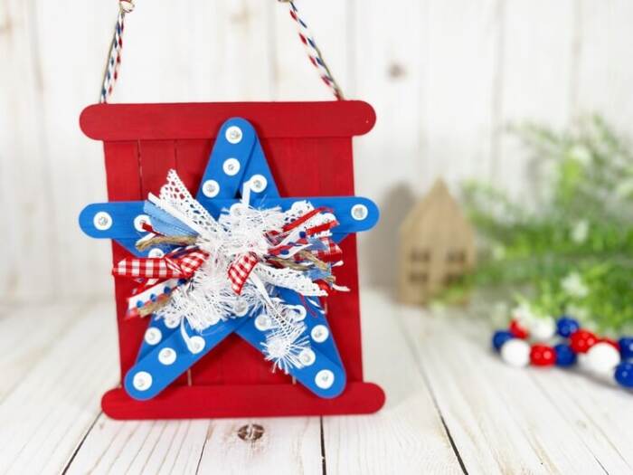 craft stick star sign on a white board background
