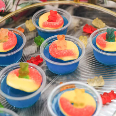 blue raspberry vodka shots on a tray