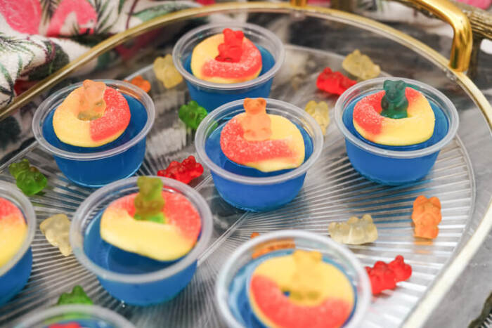 blue raspberry vodka shots on a tray
