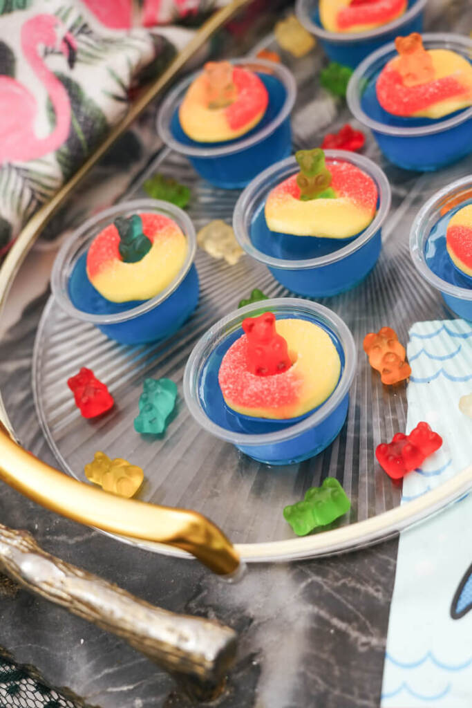 blue raspberry vodka shots on a tray
