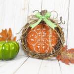 Dollar Tree Pumpkin Craft styled with green pumpkin and leaves