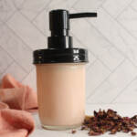 DIY Rose Lotion in a glass bottle with rose petals