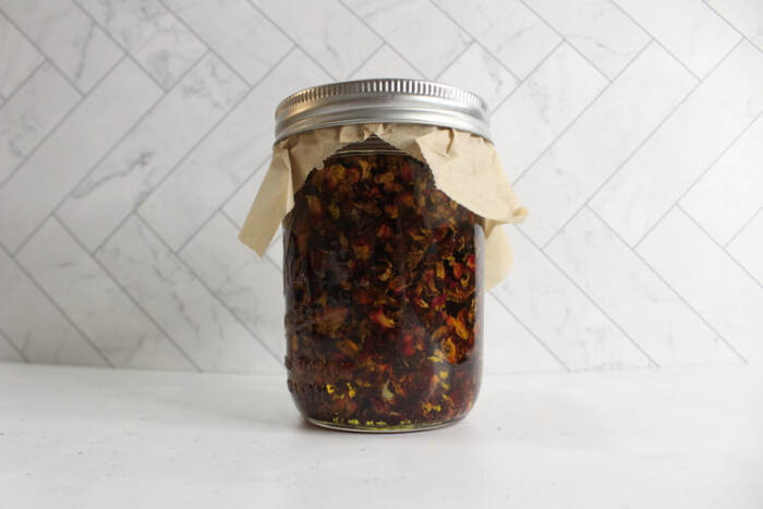 creating the rose oil in a jar