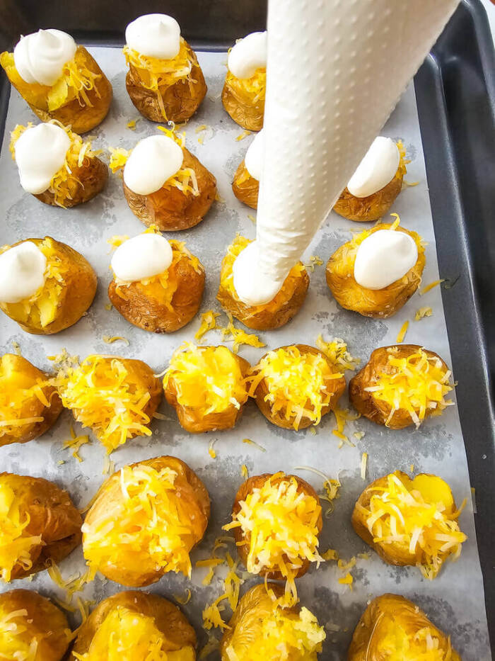 adding the sour cream to Loaded Mini baked Potato Bites