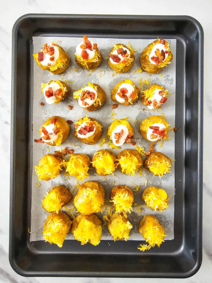 adding the toppins for Loaded Mini baked Potato Bites