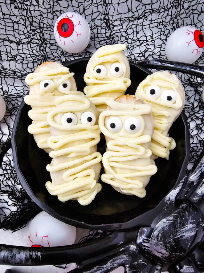 Mummy Nutter Butters on a black plate