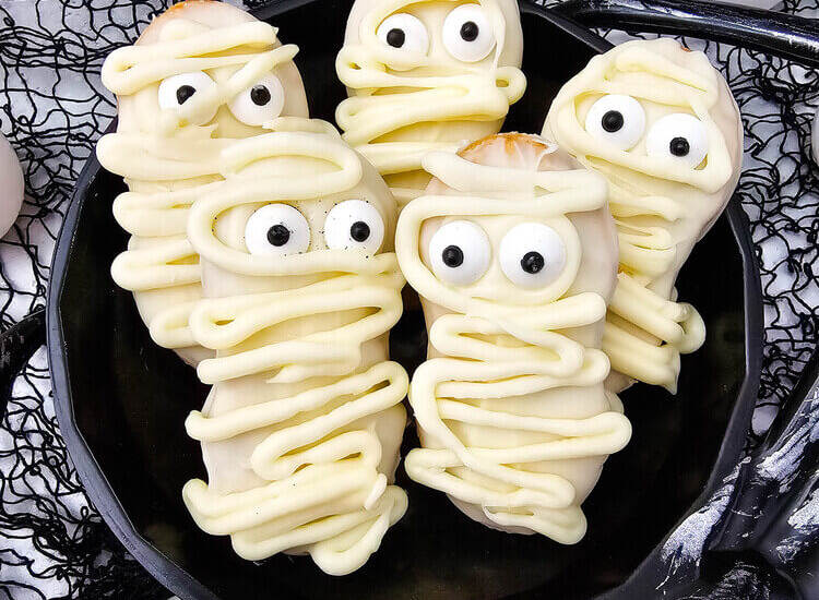 Mummy Nutter Butters on a black plate