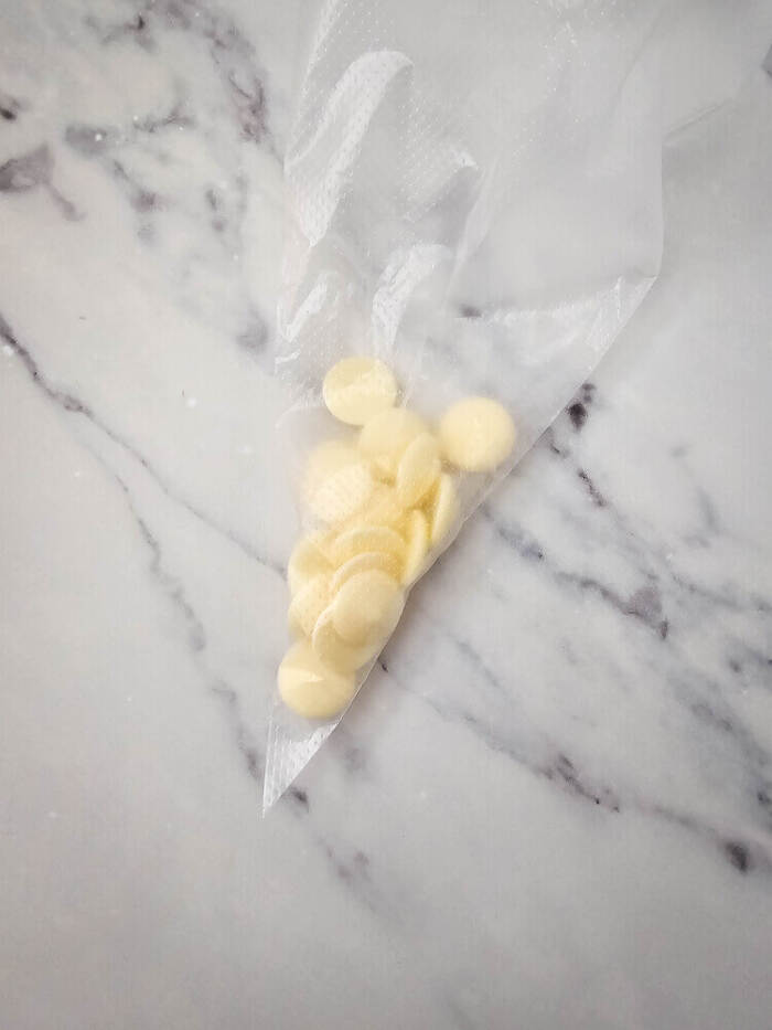 white chocolate in a piping bag before being melted