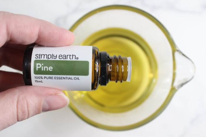 dropping pine essential oils in the oil
