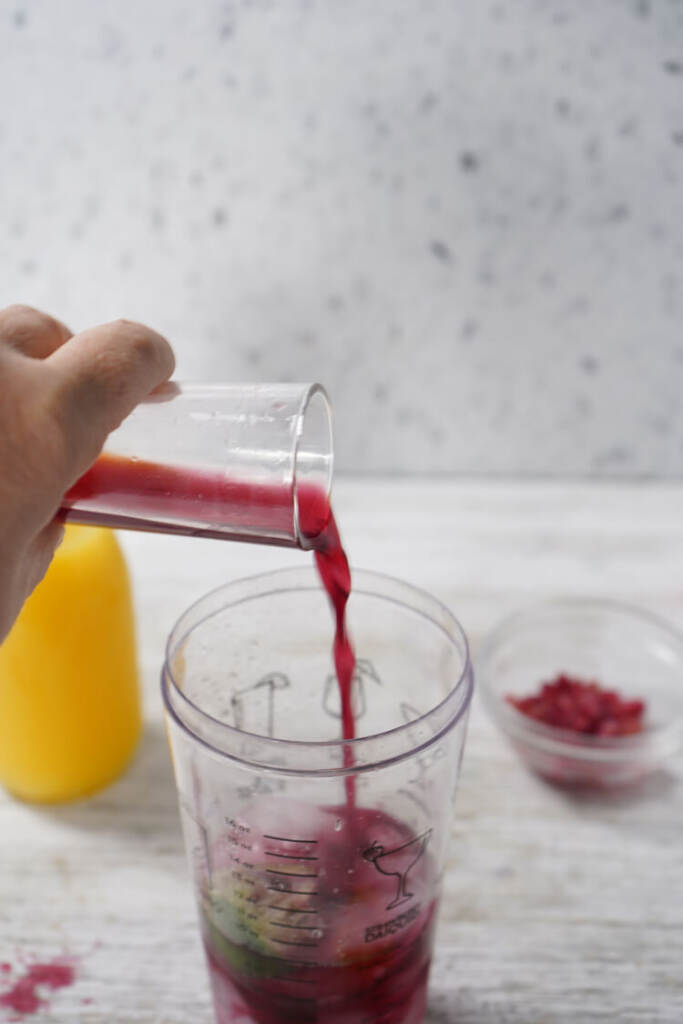 adding pomegranate to the blender