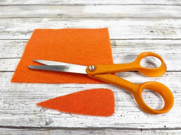 orange felt with a nose shape cut out with scissors