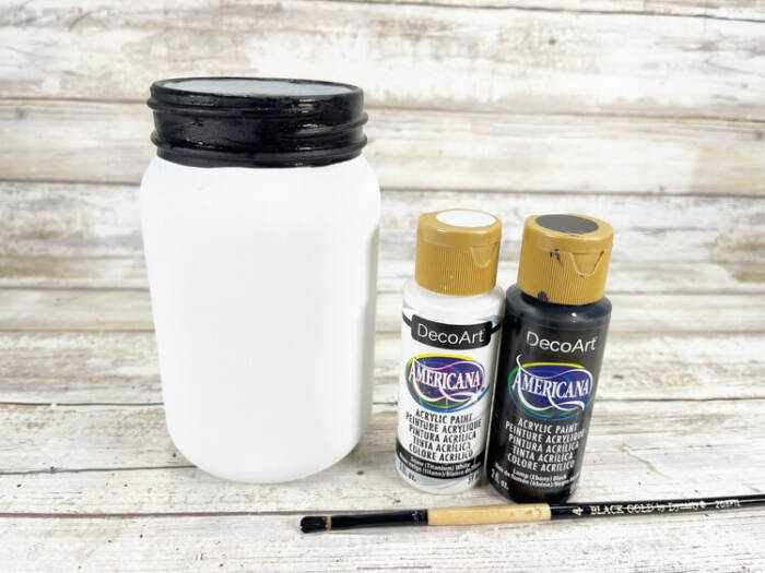 the jar painted white with the black lid