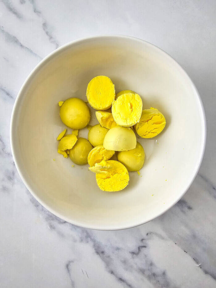 Cooked egg yolks placed in a bowl for deviled egg filling.