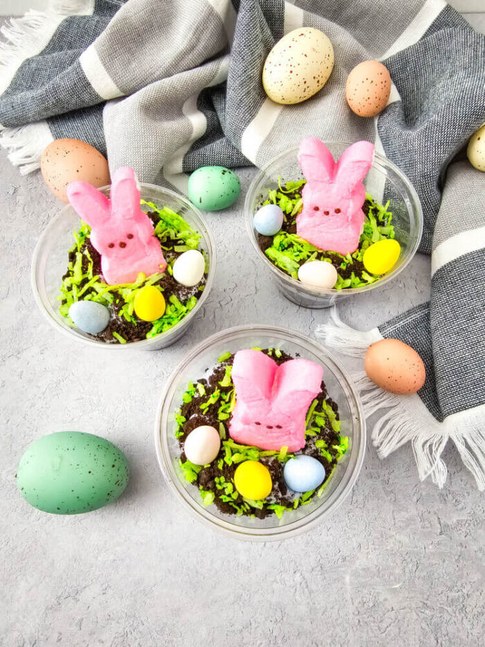 Easter Peeps Dirt Cups with pink bunny Peeps and candy eggs.