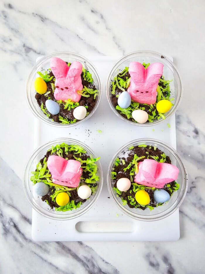 Easter Peeps Dirt Cups topped with coconut grass and bunny Peeps.