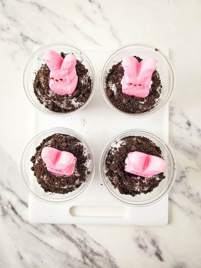 Pink bunny Peeps placed on top of Easter Peeps Dirt Cups.
