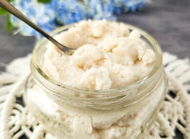 Lemon vanilla whipped sugar scrub in a glass jar with spoon.